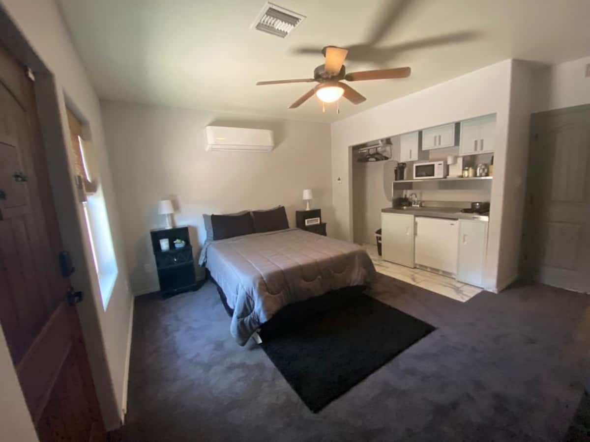 The 1-bedroom guest suite at 7951 E 36th Place: bed and kitchenette